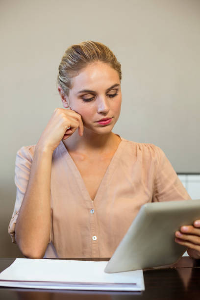 istock Focused businesswoman holding digital tablet 674403512