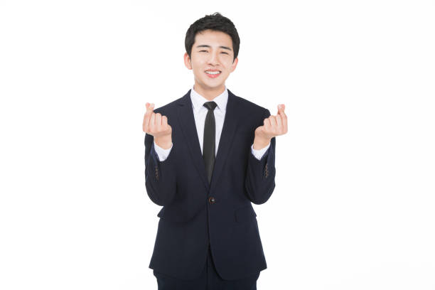 istock young handsome business man showing hand heart gesture 674403790