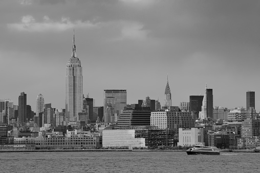 Downtown Manhattan skyline in black and white over Hudson River in New York City
