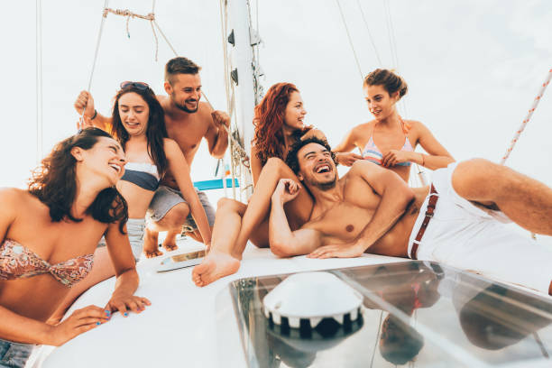 istock Happy friends on a yacht 674427810