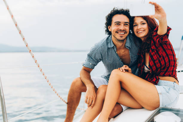 istock Couple taking a selfie on a yacht 674428024
