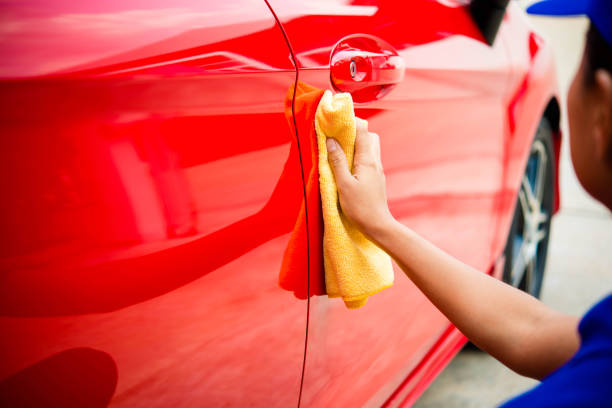 istock Worker in bule uniform cleaning car - auto detailing and valeting, service concepts 674435290