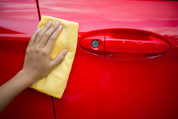 istock Worker in bule uniform cleaning car - auto detailing and valeting, service concepts 674435302