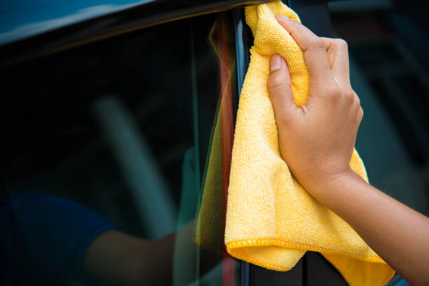 istock Worker in bule uniform cleaning car - auto detailing and valeting, service concepts 674435334