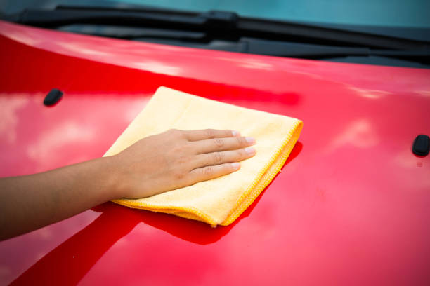istock Worker in bule uniform cleaning car - auto detailing and valeting, service concepts 674435394