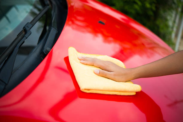 istock Worker in bule uniform cleaning car - auto detailing and valeting, service concepts 674435490
