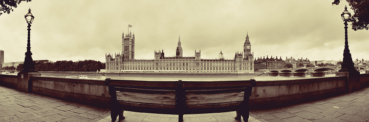 Westminster panorama with chair at waterfront in London..