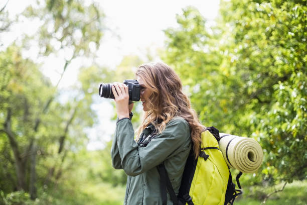 istock Woman clicking photograph with camera 674441130