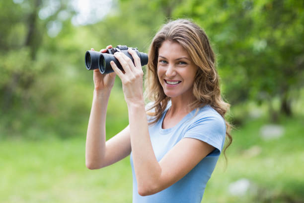 istock Portrait of young woman with binoculars 674441446