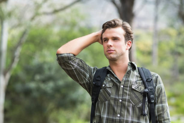 istock Young man looking away in forest 674447424