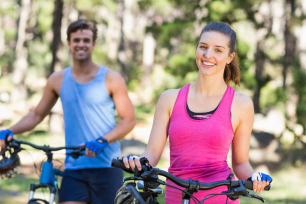 istock Woman and man with bicycles in forest 674447882