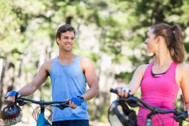 istock Happy man looking at woman with bicycles 674448000