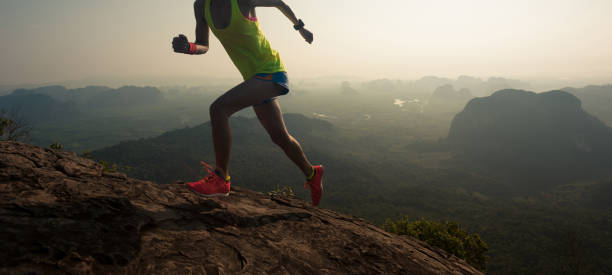 istock young woman trial runner running up on mountain top 674453224