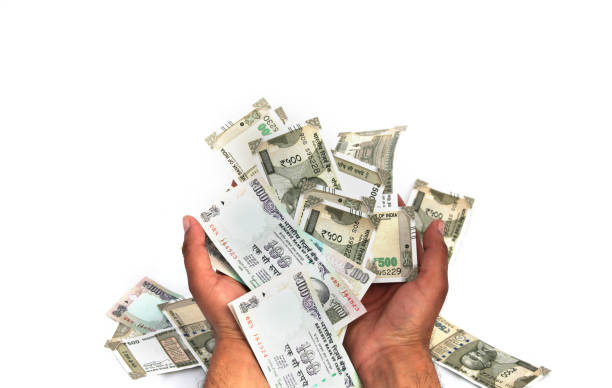 Taking bribe isolated on white background Business person holding Indian currency in hand isolated on white background. capital budget pictures stock pictures, royalty-free photos & images