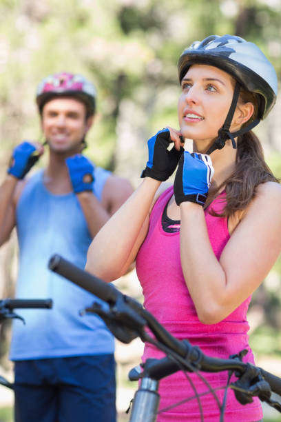 istock Male and female bikers wearing helmet 674456514