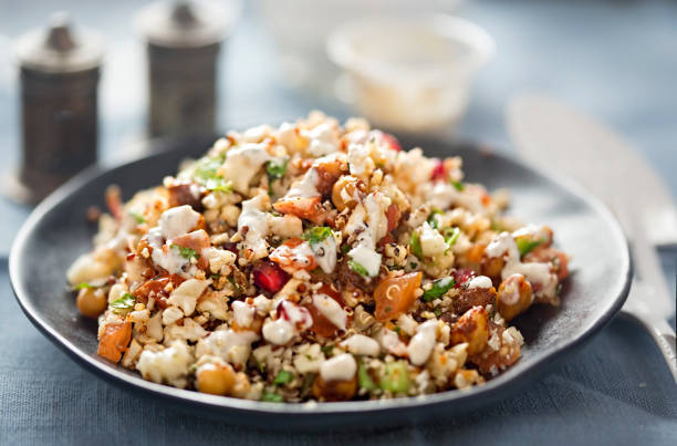 istock Cauliflower, quinoa & harissa spiced chickpeas with feta and mint dressing 674460122