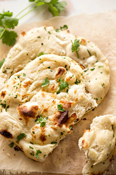 istock Coriander naan bread on wooden board 674462800