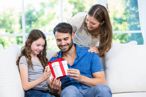 istock Family looking at gift 674463772