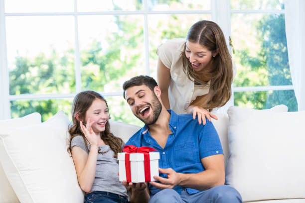 istock Man surprised with gift given by family 674463882