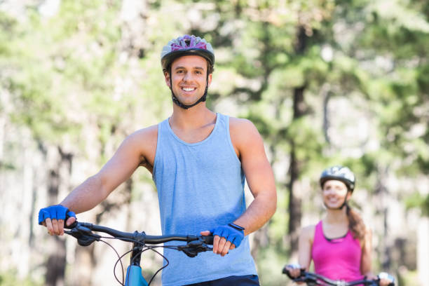 istock Portrait of young man with bicycle in forest 674467212