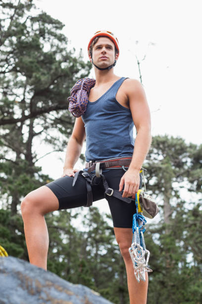 istock Low angle view of man standing on rock at forest 674469544
