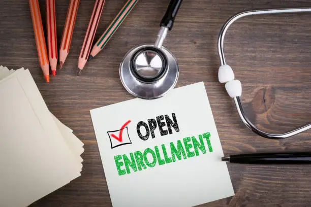 Open Enrollment. Workplace of a doctor. Stethoscope on wooden desk