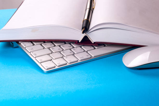 istock Office black desk table with white computer, business card blank, flower, coffee cup and pen. 674470486