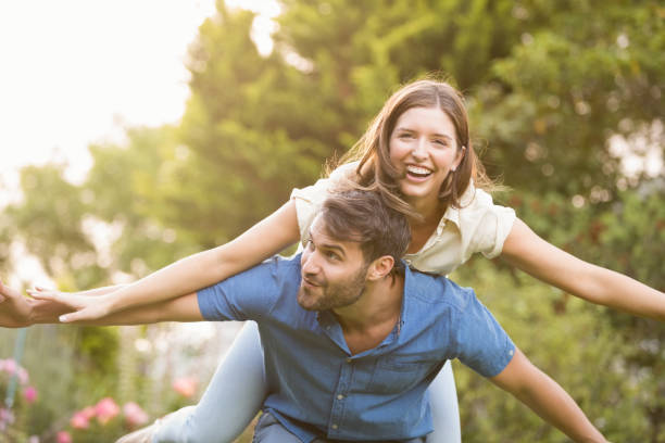 istock Happy man carrying woman on back 674473474