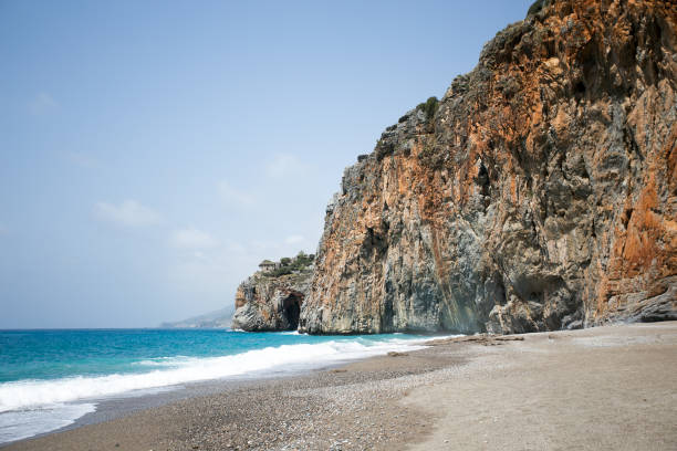 istock Mediterranean beach with turqouise sea and rocks on shore 674485292