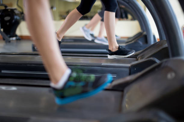 istock Low section of people running on treadmill 674487042