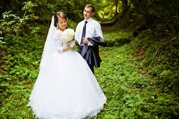 istock Wedding couple at green alley 674490186