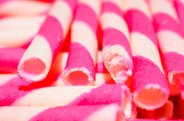 wafer rolls wafer rolls filled with strawberry stick pattern ice cream with wafer rolls stock pictures, royalty-free photos & images