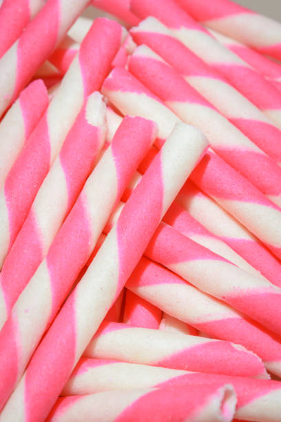 wafer rolls wafer rolls filled with strawberry stick pattern ice cream with wafer rolls stock pictures, royalty-free photos & images