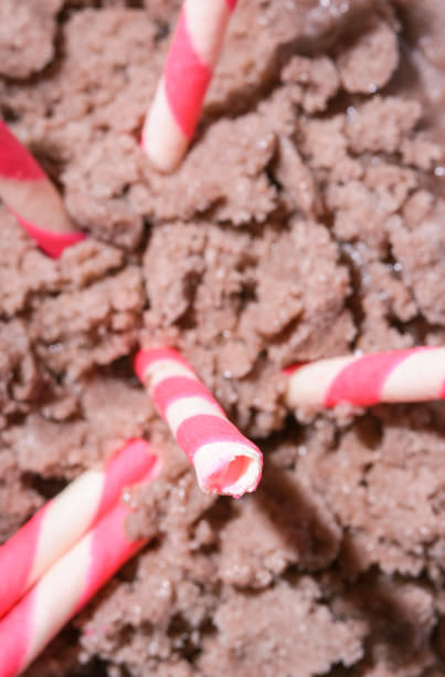wafer rolls wafer rolls filled with strawberry on ice cream. select focus ice cream with wafer rolls stock pictures, royalty-free photos & images