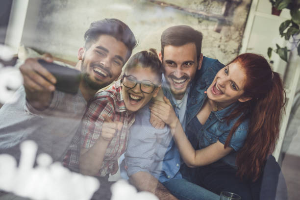 istock Happy friends having fun while taking a selfie with smart phone. 674494118