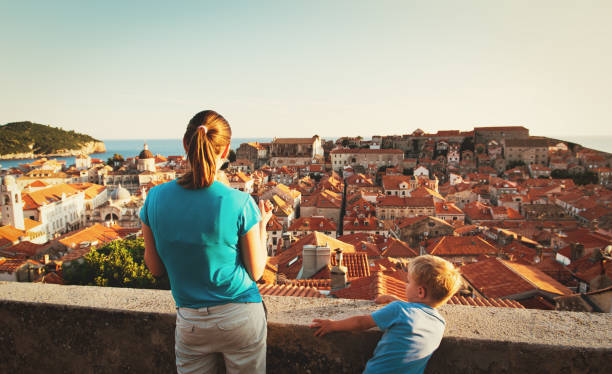istock mother with two kids looking at Dubrovnik, Croatia 674496704