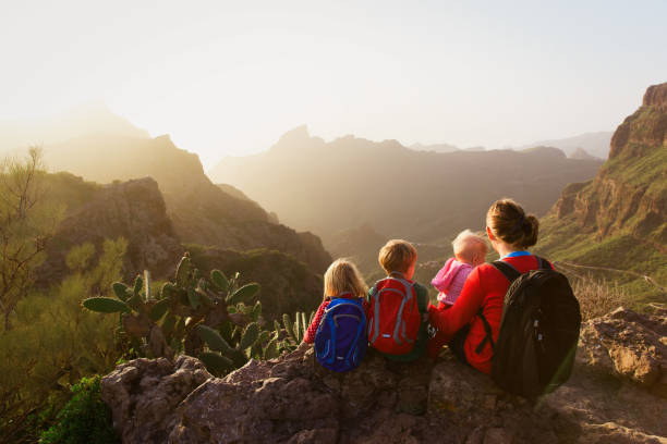 istock mother with three kids hiking in mountains 674498106