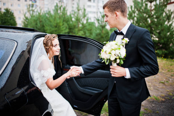 istock Groom and bride near wedding car 674500594