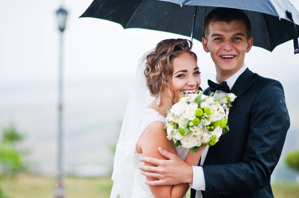 istock Happy smiled wedding couple under umbrella background lantern 674500954