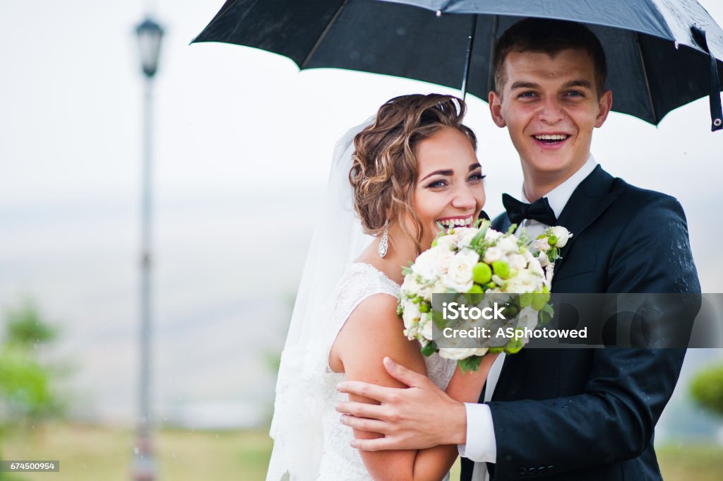 Happy smiled wedding couple under umbrella background lantern Adult Stock Photo