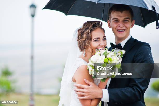 Happy Smiled Wedding Couple Under Umbrella Background Lantern Stock Photo - Download Image Now