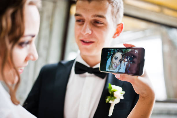 istock Wedding couple doing selfie on phone 674501402