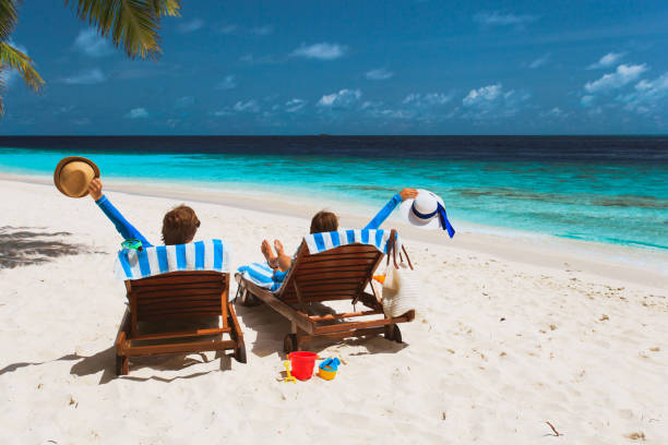 istock happy couple relax on a tropical beach 674501416