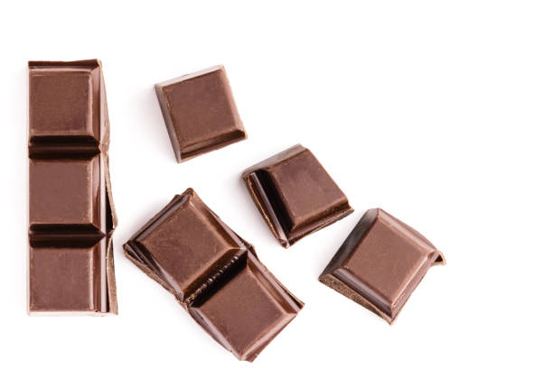 istock Chocolate cubes, pieces of bitter, dark chocolate bar, isolated on white background, top view 674501708