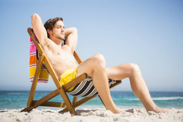 istock Man sitting and relaxing on deck chair 674504750
