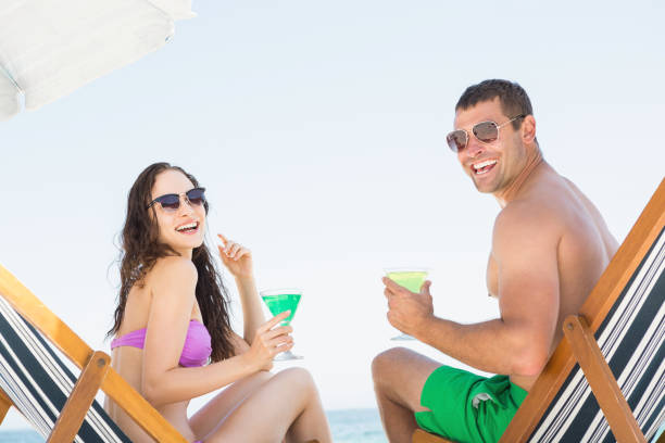 istock Couple sitting and drinking cocktails 674506834