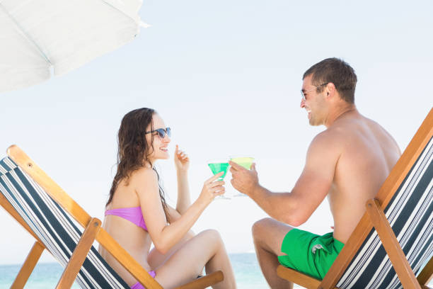 istock Couple sitting and drinking cocktails 674506912