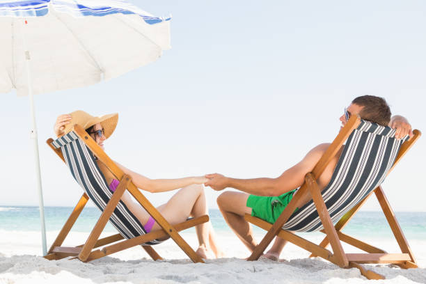 istock Happy couple sitting on deck chair 674507046