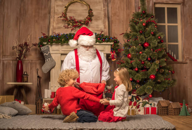 istock Santa Claus showing Christmas presents 674510724