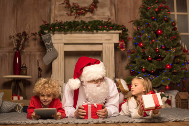 istock Santa Claus and children lying on carpet 674519366